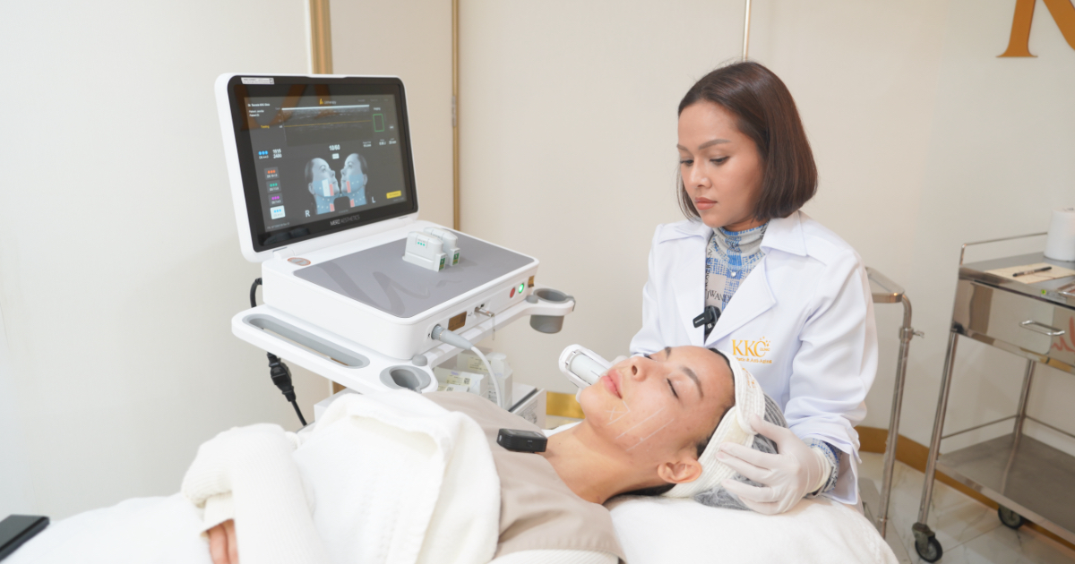 Doctor performing Ultherapy Prime using ultrasound technology to lift and tighten facial skin, with a patient lying down during treatment.